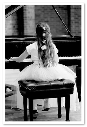 little girl playing piano at our NJ piano store